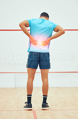 Buy stock photo Full length rearview of unknown squash player suffering from backache during court game. Fit active mixed race athlete standing and feeling pain. Cgi and special effects on sports injury after playing