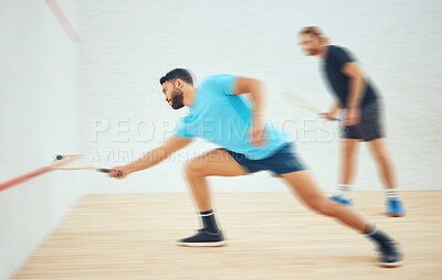 Buy stock photo Two athletic squash players playing match during competitive court game. Fit active mixed race and caucasian athlete competing during training challenge in sports centre. Full length with motion blur