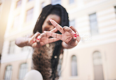 Hands, peace sign and city woman on street with blurred building background, smile and urban fashion. Peace, empowerment and young black woman at outdoor buildings with happy cool style and in Africa