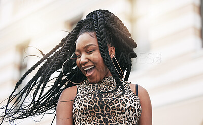 Buy stock photo Hair, freedom and fashion with a fun black woman in the city on a summer day feeling cheerful or carefree. Braids, free and trendy with a young female in town on an urban background with flare