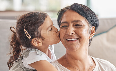 Buy stock photo Love, family and kiss with girl and grandma together for happy, retirement or mothers day celebration. Smile, hug and  proud with child and grandmother at home in embrace for birthday or care