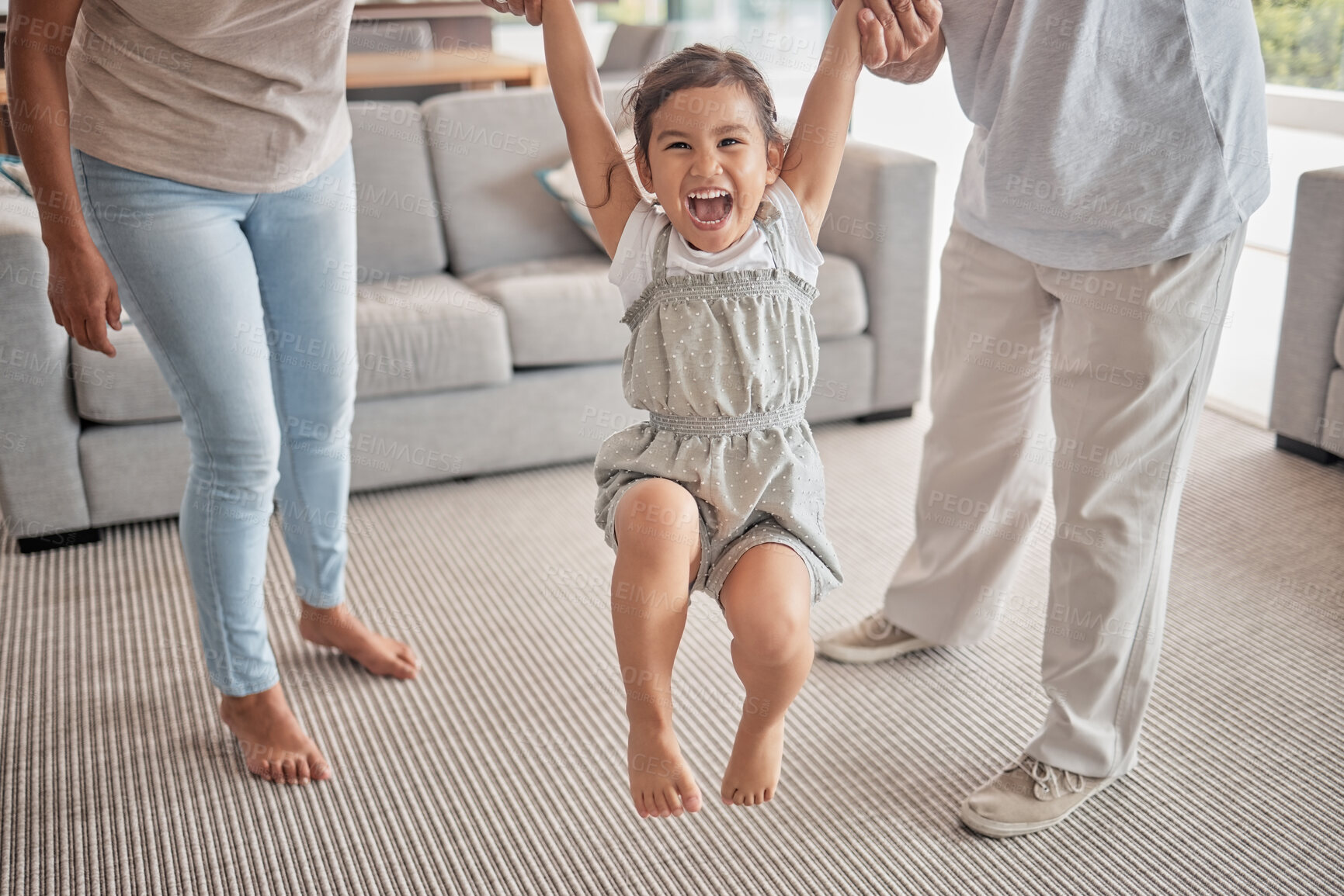 Buy stock photo Happy child jump on carpet with grandparents holding hands for support, love or care in living room. Excited kid girl with family with legs game or exercise for growth development with people helping