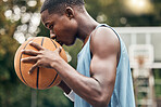Sports, fitness and man with a kiss to a basketball in training, workout and athletic exercise outdoors. Culture, wellness and young player or athlete with passion and love for playing on court 