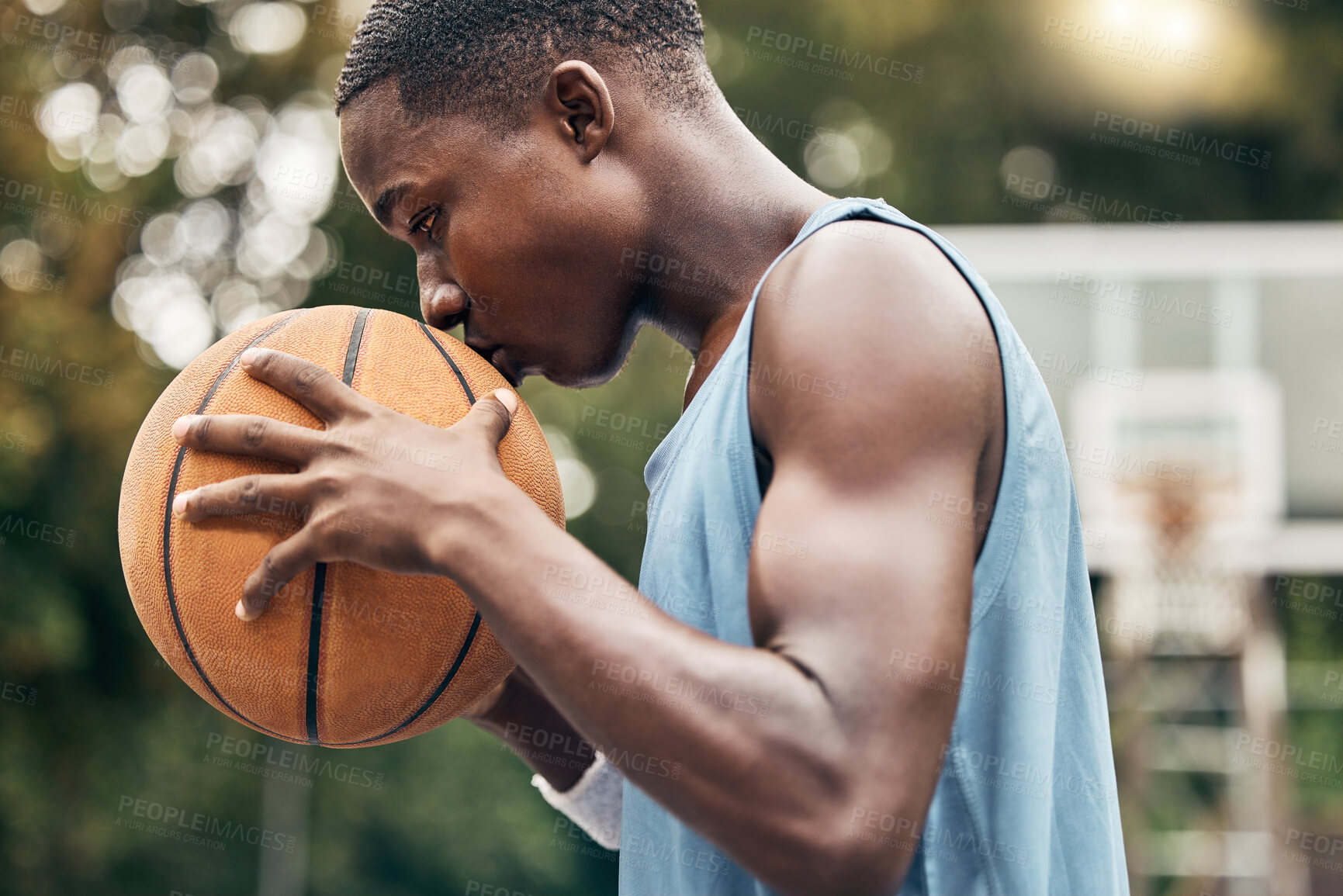 Buy stock photo Sports, fitness and man with a kiss to a basketball in training, workout and athletic exercise outdoors. Culture, wellness and young player or athlete with passion and love for playing on court 
