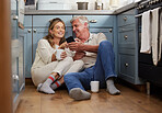 Senior couple, phone or bonding with morning coffee on house or home hotel kitchen floor in trust, love or security. Smile, happy or technology for retirement elderly man and woman with internet news