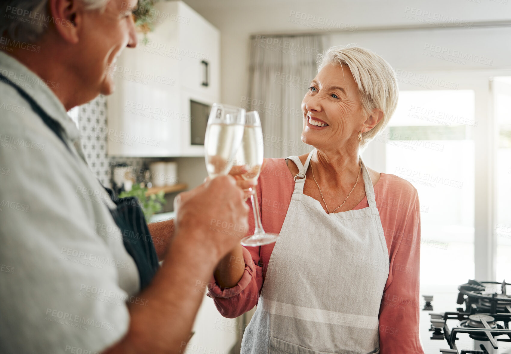 Buy stock photo Senior couple, champagne and drinks toast in house or home kitchen in marriage anniversary, celebration event or retirement security success. Happy smile, love or elderly man, woman and alcohol glass