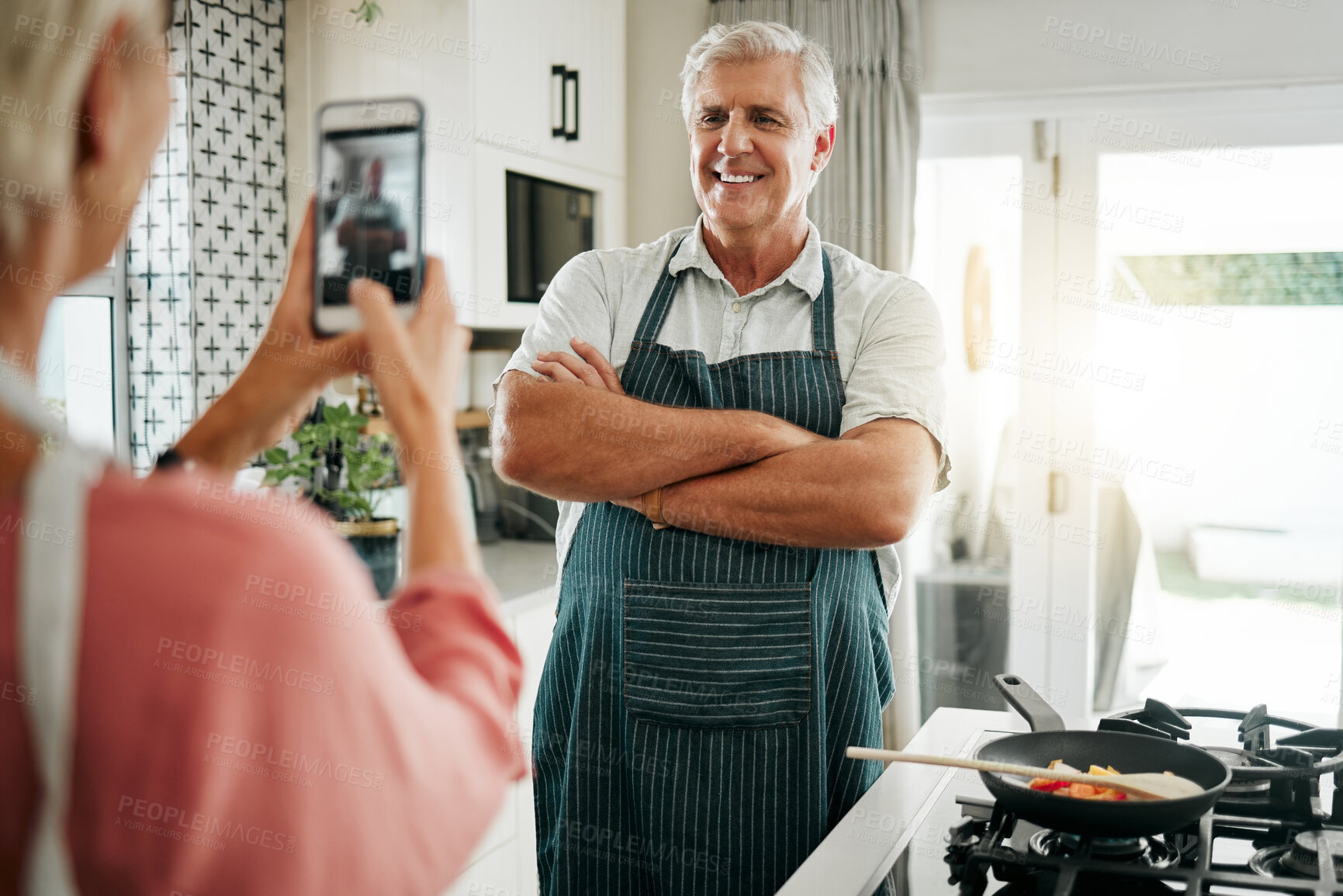 Buy stock photo Senior man, phone and cooking photograph by woman for social media, live streaming or food vlog in Canada house kitchen. Smile, happy or confident home chef for about us website picture on technology