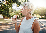 Senior woman blowing dandelion flower outdoors for freedom, hope and spring allergies environment. Elderly retirement lady holding plant for wellness, healthy lifestyle and pollen allergy in nature