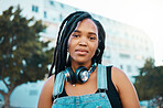 City, urban and headphones black woman portrait in urban gen z fashion, outdoor travel or youth lifestyle. Young, trendy african girl or student face with technology for 5g audio streaming in summer