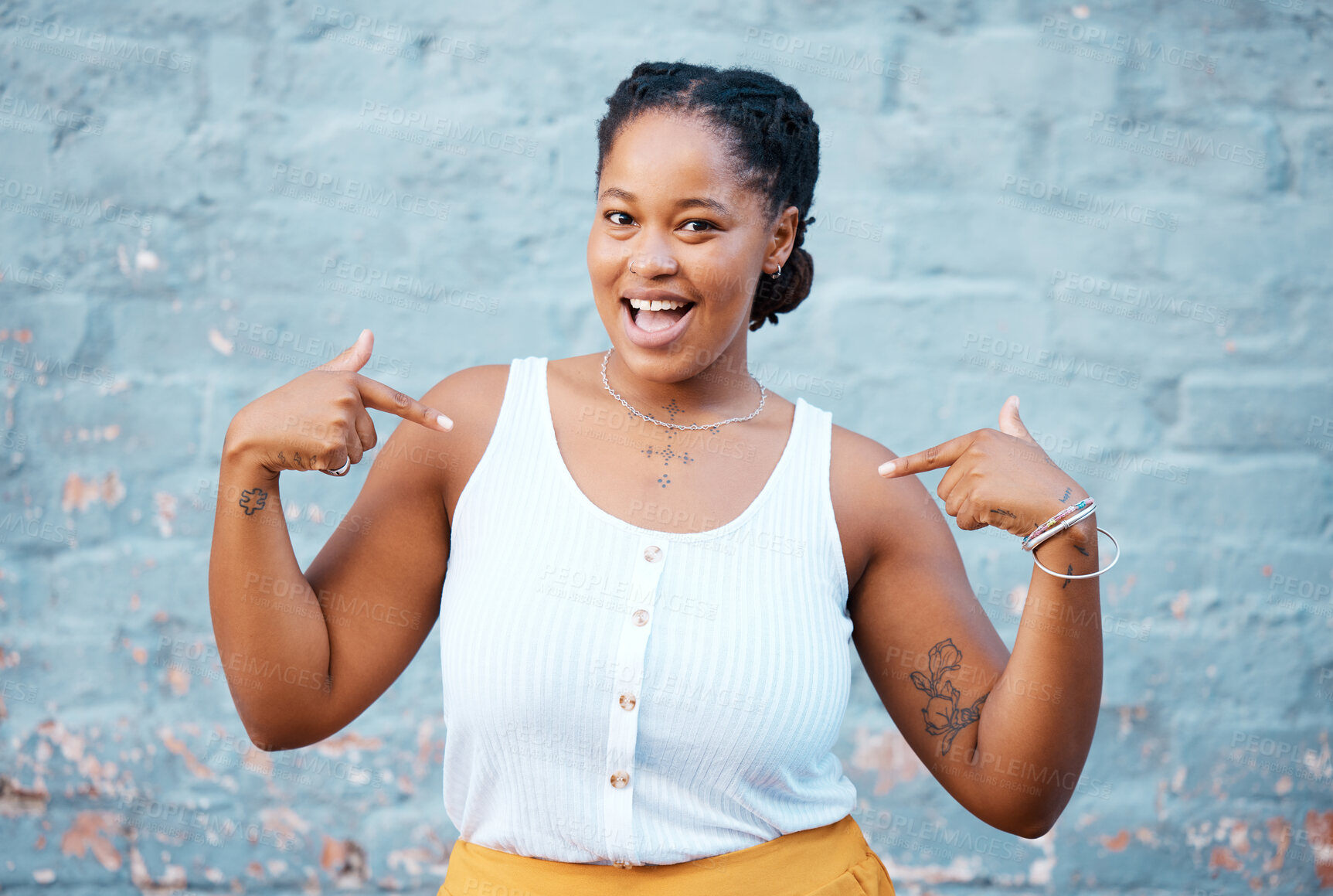 Buy stock photo Black woman, pointing and happy feeling proud and self assured choosing herself against city building wall, mockup space or outside in Nigeria. Portrait of African model with a fun or playful gesture