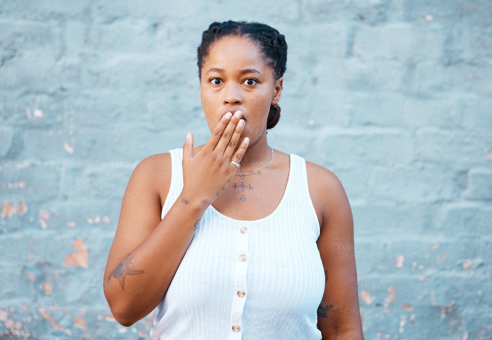 Buy stock photo Shocked black woman, hand and worry in silence for secret against a wall background. Portrait of African American female covering mouth in concerned facial expression for gossip, news or emoji