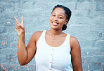 Portrait, peace sign and happy black woman with wall background smiling and standing proud and content alone. Smile, natural and young African girl in Nigeria with a positive hand gesture outdoors