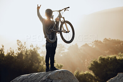 Buy stock photo Mountain bike, adventure and winner man with rock, success or celebration sign and bicycle for outdoor competition. Motorcycle travel person celebrate winning goal with sunshine, sky or nature mockup