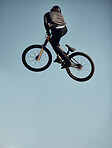Cycling, bicycle and man doing a sky jump trick for a sports freestyle competition, game or travel race. Air mockup, energy and mountain bike person doing exercise, workout or fun fitness training