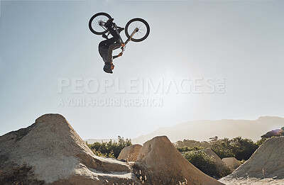 Buy stock photo Mountain bike jump training man on rocks hill cycling in air, blue sky mockup for professional performance, training or outdoor bike exercise. Sports person on outdoor motorcycle or bicycle adventure