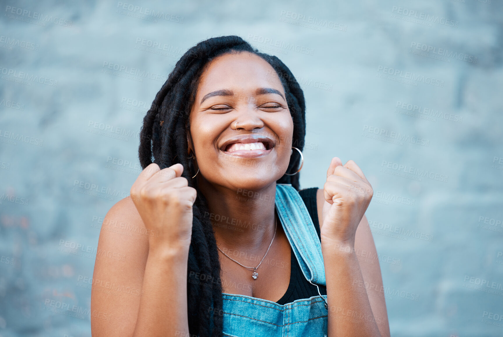 Buy stock photo Black woman, happy and excited smile of a winner from Jamaica feeling happiness. Smiling face of a person with excitement, positive energy and gratitude mindset with a gray brick background