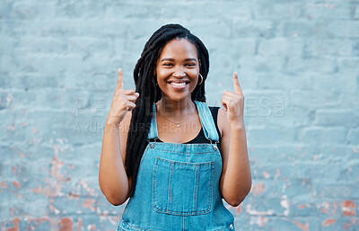 Buy stock photo Mockup portrait of happy black woman pointing for marketing, advertising or news announcement. Happiness, smile and young gen z student girl with mock up hands sign isolated on blue background wall