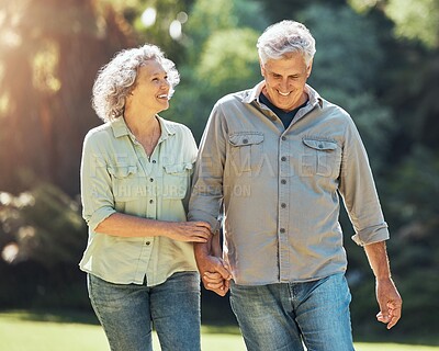 Buy stock photo Nature, walk and a senior couple holding hands in park laughing and romance in retirement. Outdoor garden, love and elderly man and happy woman on romantic walking date in a field on summer weekend
