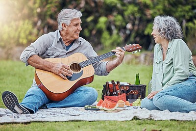 Buy stock photo Retirement, love and guitar with couple on picnic in park together for relax, summer or food. Nature, wellness and happy old man and woman listening to music in countryside field for health in spring