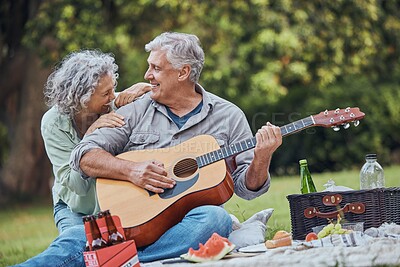 Music, guitar and a senior couple on picnic in park laughing with food, drinks and romance in retirement. Nature, love and elderly man and happy woman on romantic date on the grass on summer weekend.
