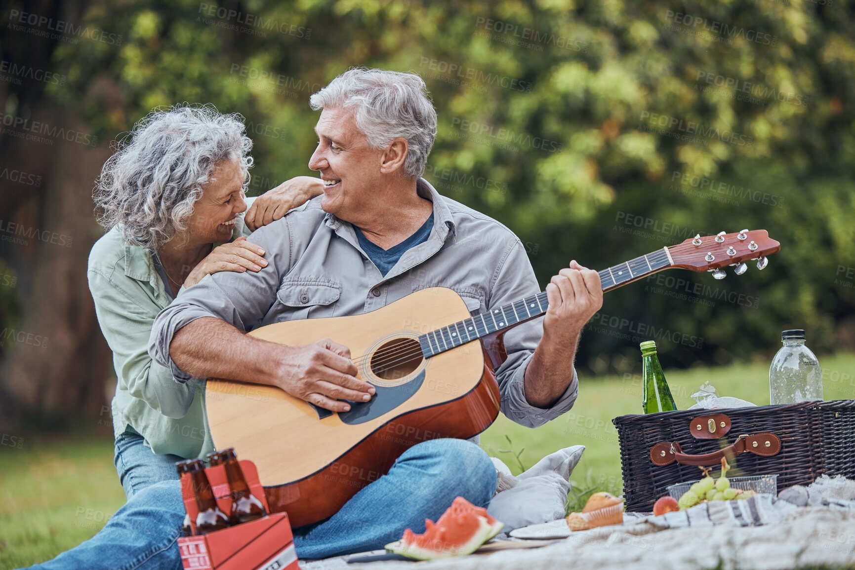 Buy stock photo Music, guitar and a senior couple on picnic in park laughing with food, drinks and romance in retirement. Nature, love and elderly man and happy woman on romantic date on the grass on summer weekend.