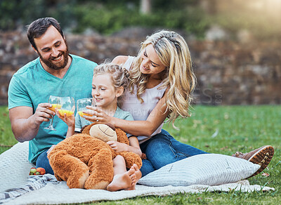 Buy stock photo Children, family and picnic with a girl, mother and father sitting outdoor on a grass field in a park with a drink or glass of juice. Kids, summer and bonding with a man, woman and daughter together