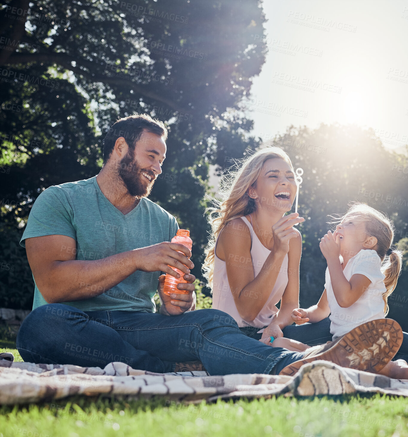 Buy stock photo Family, happy and bubbles with picnic in park together for summer, relax and nature. Smile, spring and peace with parents playing with girl in countryside field for youth, lifestyle and happiness 