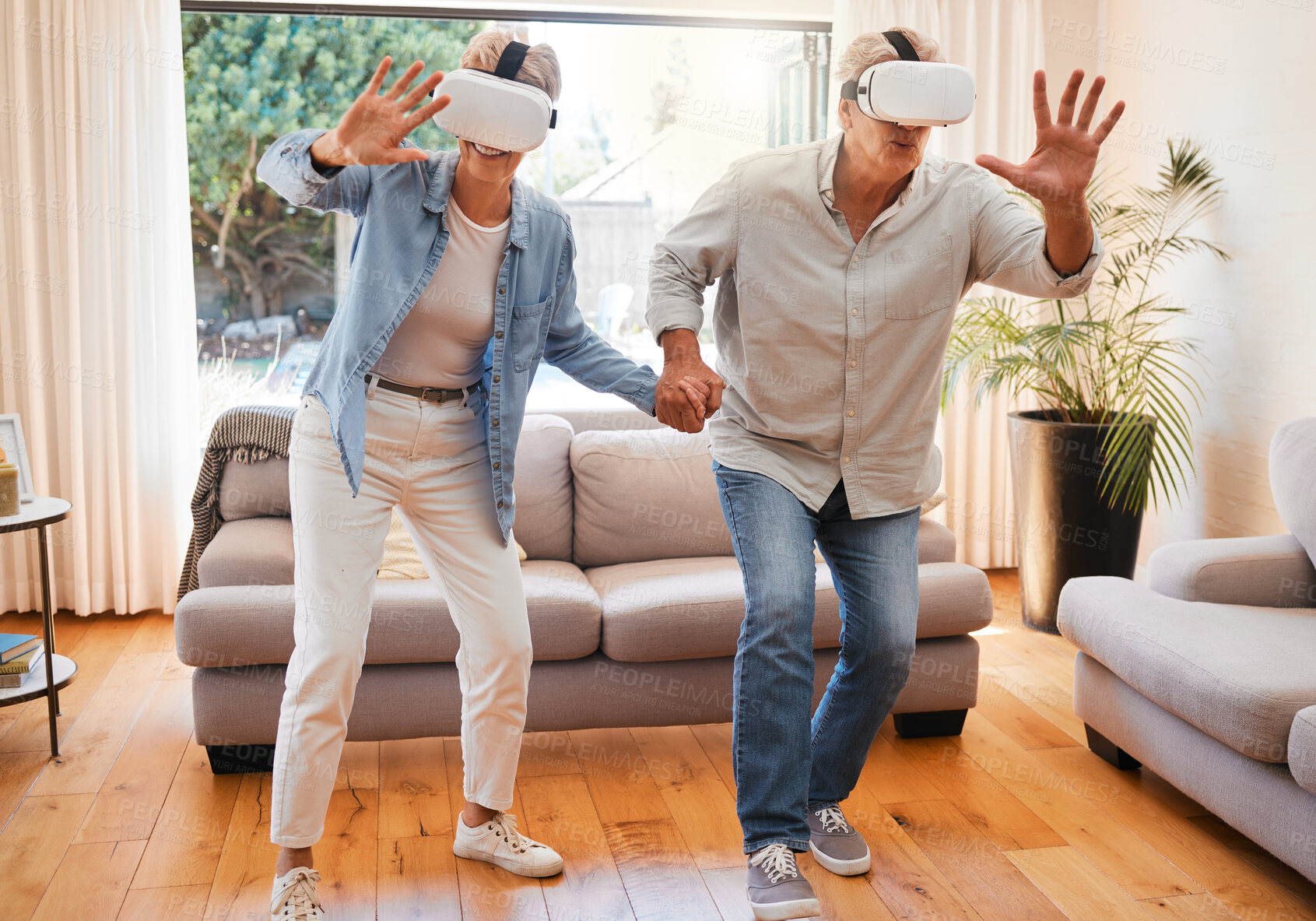 Buy stock photo Metaverse, vr headset and senior couple in fun 3d play game in lockdown house or home living room. Virtual reality, cyber esports and digital gaming for retirement elderly man and woman holding hands