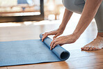 Yoga, hands and woman rolling mat in fitness studio after workout and meditation. Gym, pilates and meditating for health and mindfulness. Relax, calm and zen, exercise for mental health and wellness.