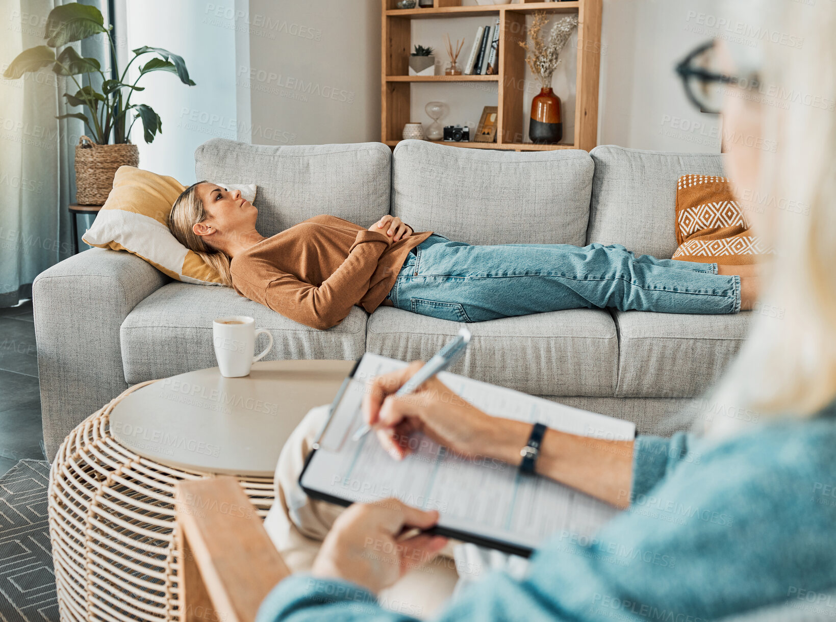 Buy stock photo Relax, psychology and therapist with woman patient struggling with depression resting on sofa. Professional psychologist analysis notes for consultation to help emotional mental health client.