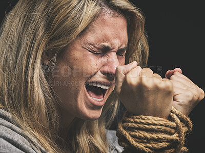 Buy stock photo Danger, scared and horror woman scream for help with hands tie and trapped by rope on black studio background. Violence, sad or anxiety female with crime, fear and prisoner, crying for mental health