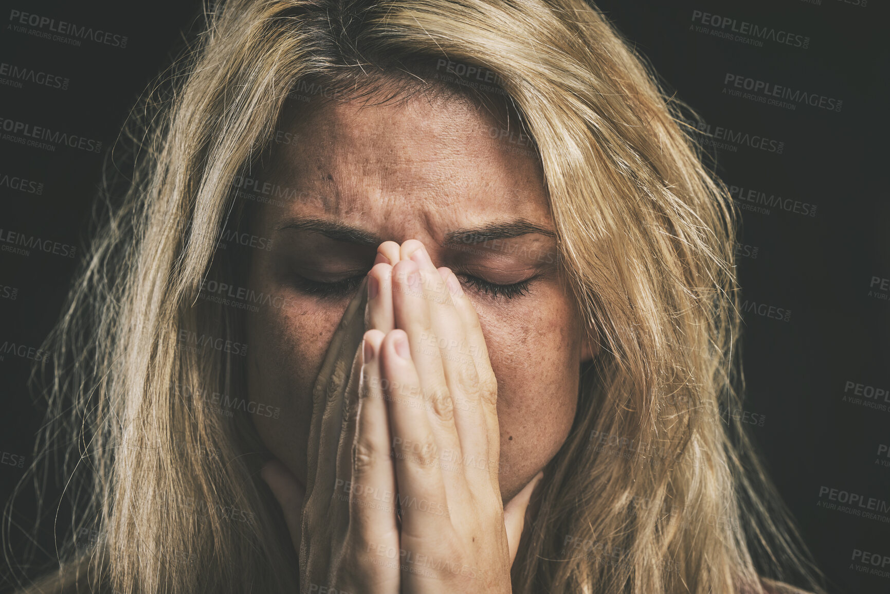 Buy stock photo Stress, anxiety and depression with a mental health woman suffering from a headache or migraine in a studio on a dark background. Cancer and sad young female covering her face in fear and distress