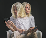 Phone communication, bipolar and senior woman typing on mobile app with mental health problem against a black mockup studio background. Elderly person with schizophrenia, depression or anxiety on web