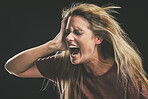 Anxiety, frustrated and trauma woman crying in dark studio for psychology and mental health mock up. Depressed, bipolar or angry girl shout for depression, mental health problem on a black background