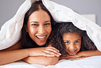 Children, family and bedroom with a girl and mother in bed together for love, care and bonding in the home. Kids, trust and happy with a woman her daughter in their house to relax in the morning