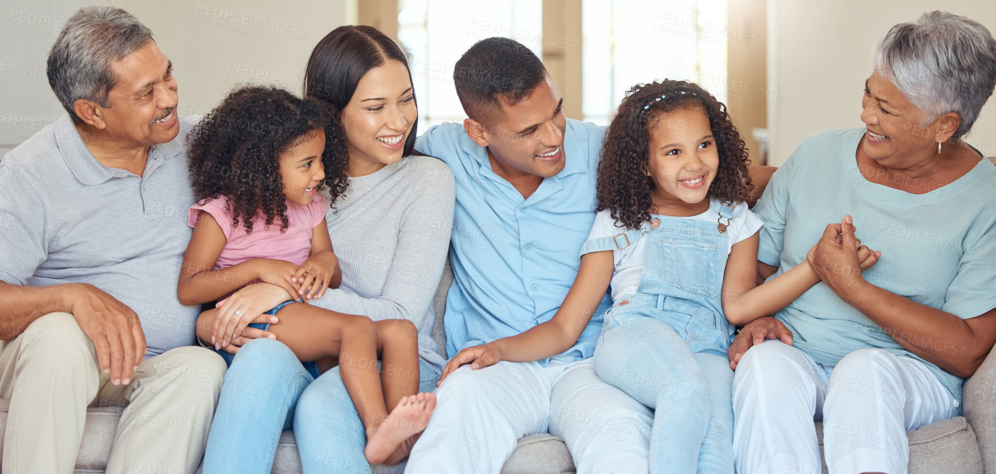 Buy stock photo Love, happy family and relax on a sofa, laughing and bonding in a living room together in their family home. Kids, grandparents and loving parents enjoying free time and conversation together indoor