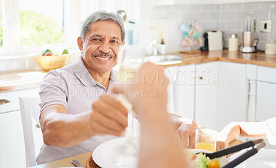 Buy stock photo Champagne, glass and senior couple man for birthday celebration in Mexico home kitchen. Happy elderly people celebrate holiday with alcohol wine, eating lunch or brunch together for retirement wealth