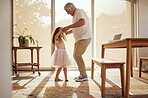 Grandfather, girl and dance holding hands in living room home. Love, smile and happy cute daughter dancing with caring grandpa spending time together, bonding and care having fun on weekend in house.