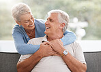 Love, family and senior couple hug and relax on a sofa, bonding in living room together. Retirement, happy family and mature man and woman enjoy their relationship and conversation in their home