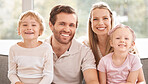 Family, children and smile on sofa for portrait together in living room happy in home, vacation or holiday. Mom, dad and kids show happiness, love and bonding on couch in lounge at their house