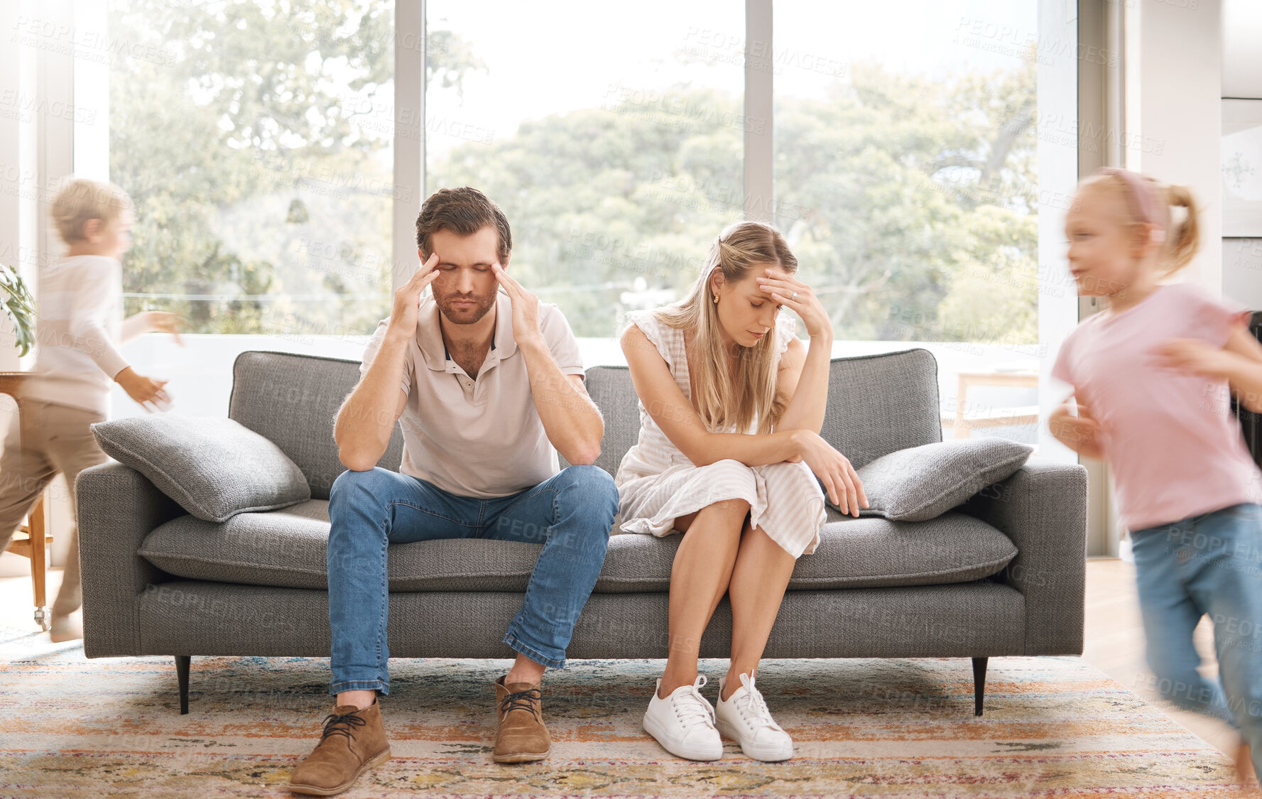 Buy stock photo Noise, headache and stress with children and parents in a living room, overwhelmed by adhd kids energy. Burnout, anxiety and family in crisis, suffering from behaviour problem and fatigue