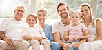 White, big family and portrait smile on sofa relaxing in happiness for bonding and time together at home. Happy parents, grandparents and children smiling in comfort and relax on living room couch