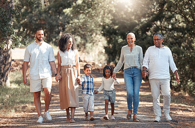 Buy stock photo Summer, happy and black family walk in a park, bonding and having fun in nature together, cheerful and content. Love, kids and grandparents enjoying conversation and family time, smile and hold hands