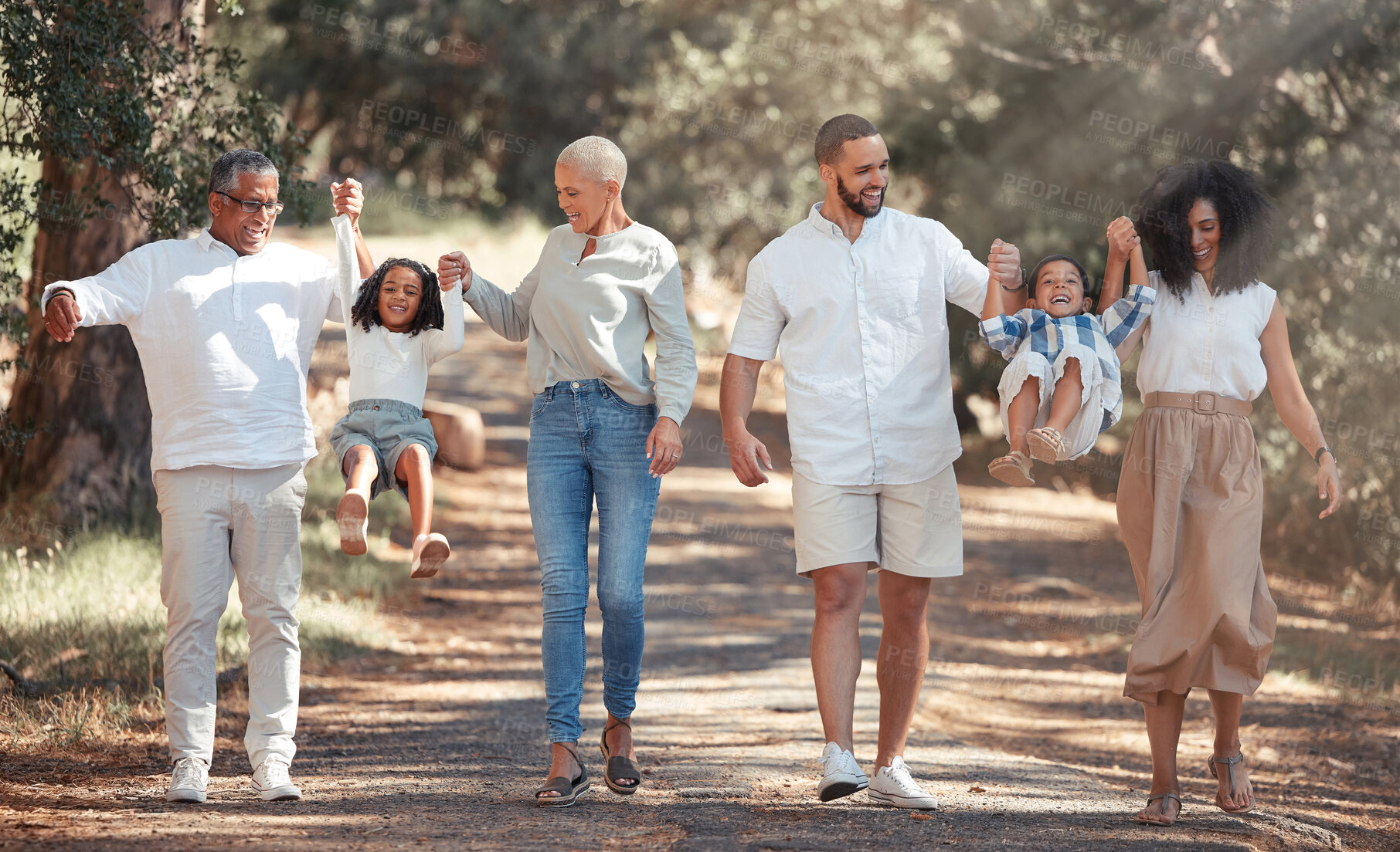 Buy stock photo Big family walking in park holding hands for love, support and care on summer travel vacation in forest nature. Wellness, health and child development with grandparents and children or kids in woods