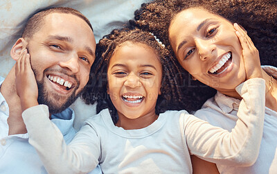 Buy stock photo Family, girl and above smile in portrait on bed for happy closeup together to relax together while laughing. Mother, dad and kid show happiness, love and fun for comic, funny or silly joke on blanket