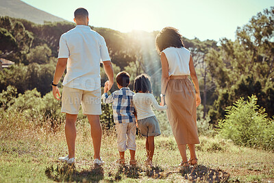Buy stock photo Family, walk and nature together with trees, grass and sunshine while on vacation. Mom, dad and children walking in forest, field or park in spring for ecology of plants in countryside, woods or wild