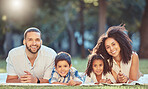 Relax, picnic and happy family rest together in a park, having fun and bonding on grass together. Love, smile and portrait of cheerful parents enjoy time in nature with excited kids, smiling kids