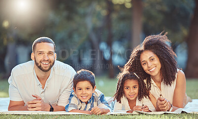 Buy stock photo Relax, picnic and happy family rest together in a park, having fun and bonding on grass together. Love, smile and portrait of cheerful parents enjoy time in nature with excited and smiling kids 