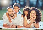 Family, children and smile on grass with blanket to relax show love, care and happiness outdoors. Mom, dad and kids on picnic in park, garden or backyard smile together in sunshine while in Toronto