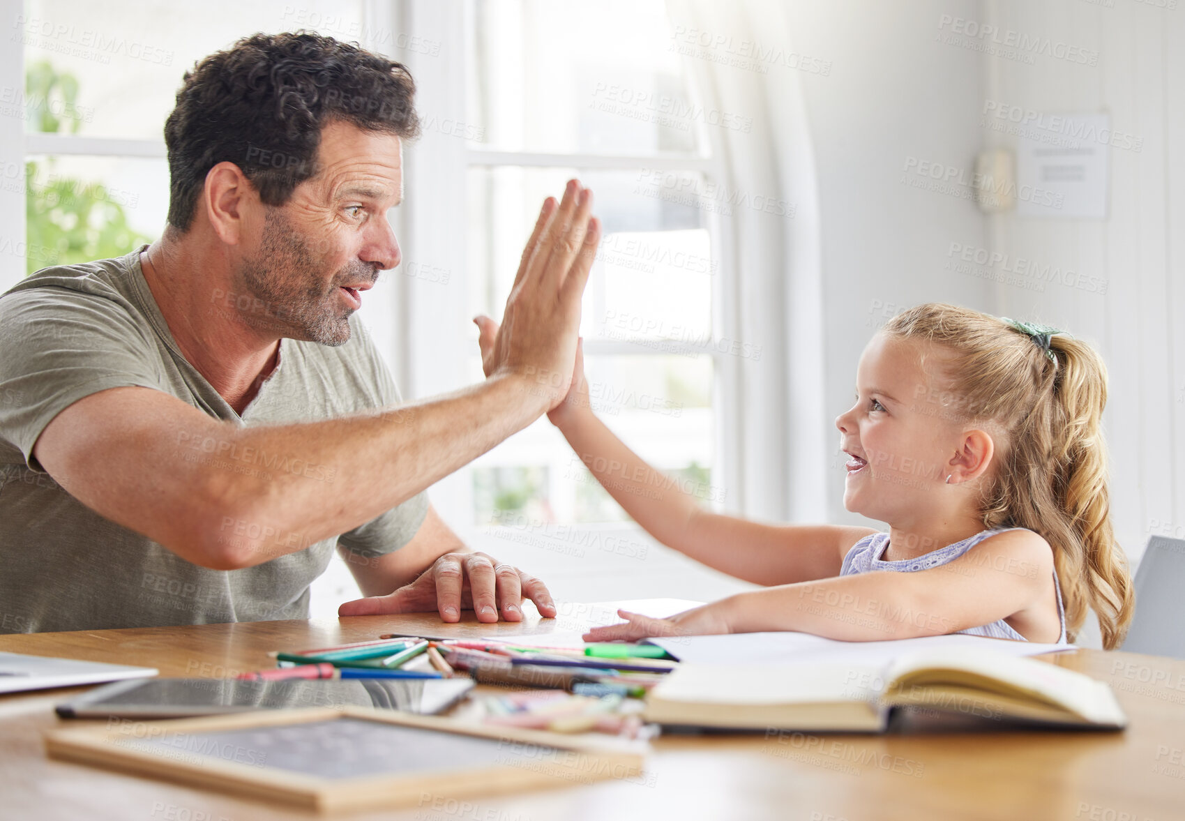 Buy stock photo Education, learning and high five for girl in support of success and educational goal by father, excited and bonding at a table. Motivation, winning and happy parents help child with creative project